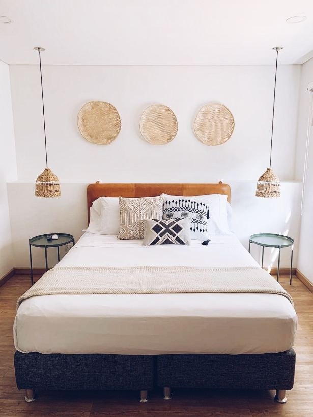 Deluxe Room with queen bed, woven baskets and twin rattan pendant lamps