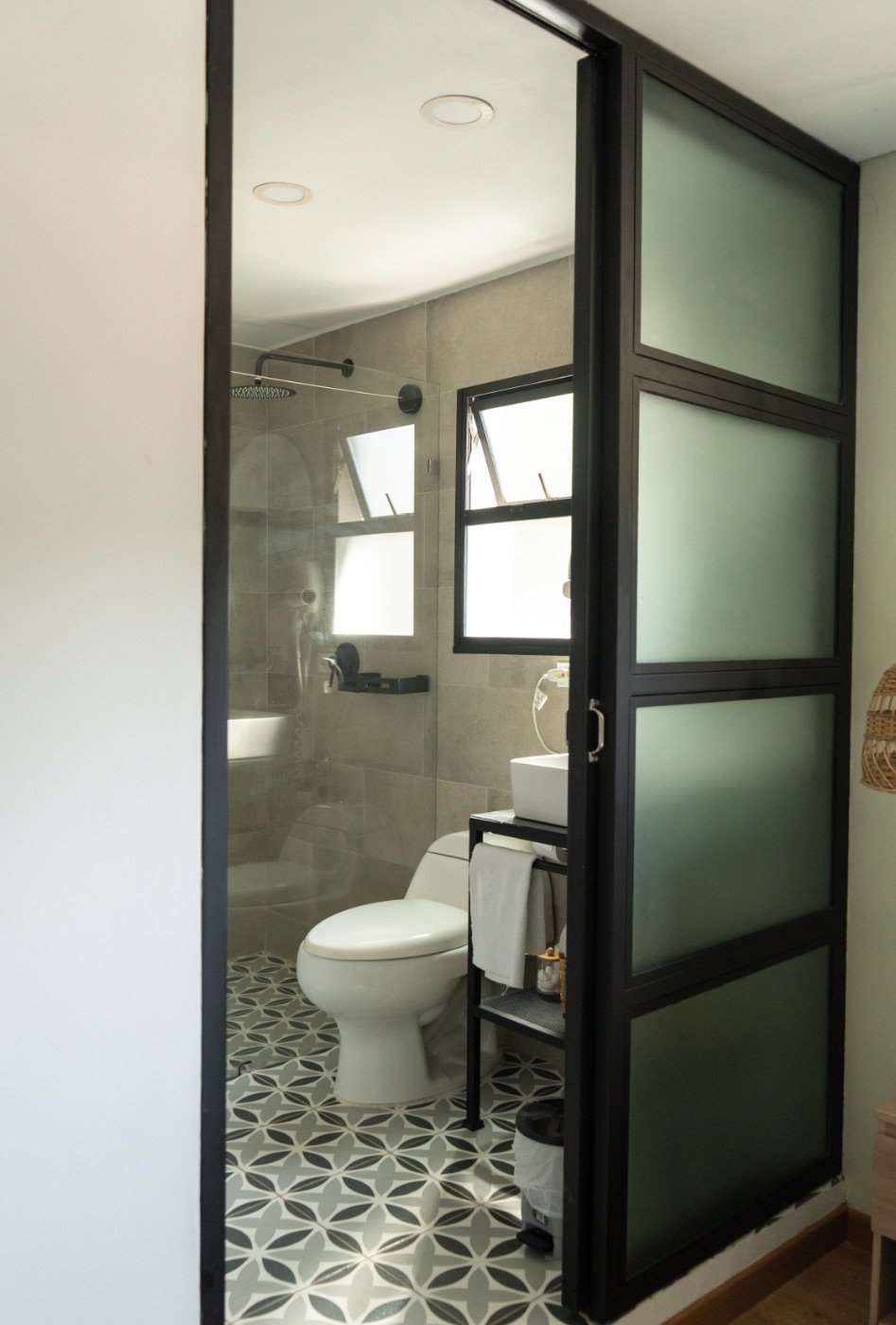 Standard Room bathroom with rain shower and patterned tile floor
