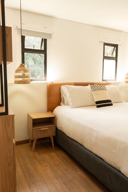 Hot Tub Room bedroom with a wood-slat headboard and warm lamp light