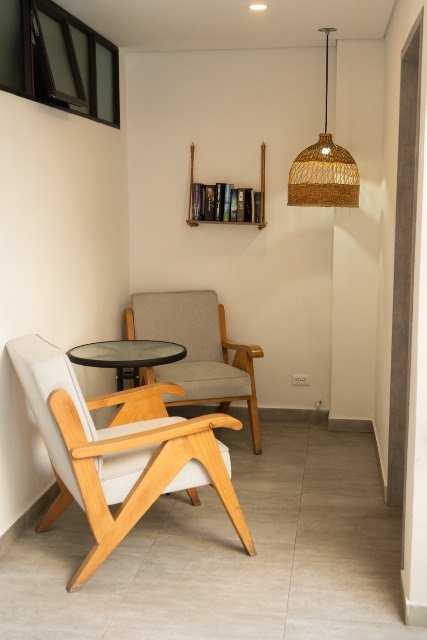Cozy reading nook with a rattan pendant lamp